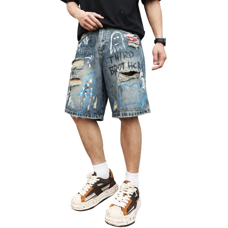 Blue denim shorts for men with rips and a graffiti pattern, featuring a zipper fly.