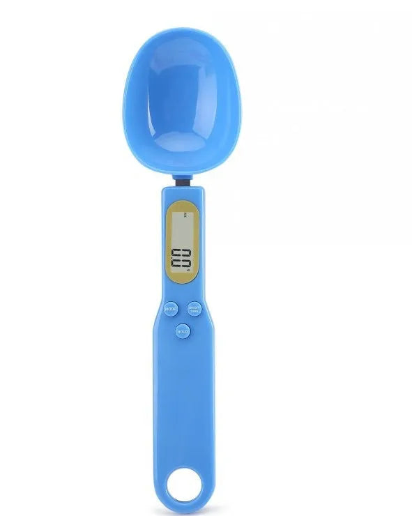 White digital spoon scale with LCD display measuring 500g capacity on a kitchen surface