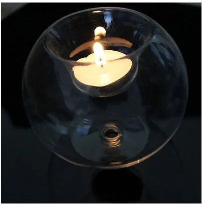 Handmade round clear glass candle holder on a table