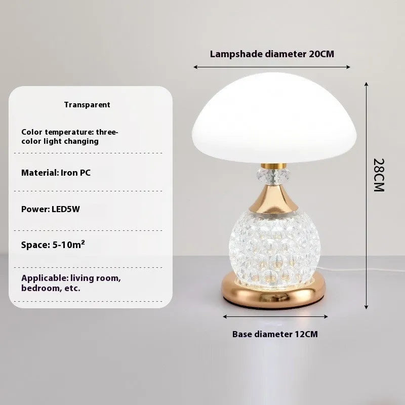 Light luxury mushroom table lamp in transparent colour option on a bedroom desk with USB cable connected.