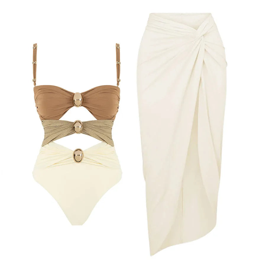 Women's black one-piece swimsuit with a removable skirt and gold button details on the front.