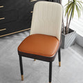 Leather horseshoe-shaped seat cushion in a solid colour on a chair, showing non-slip base.