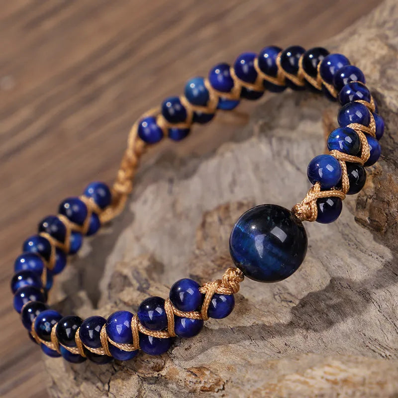 Close-up of a handmade woven bracelet with geometric tiger eye beads on an adjustable band.