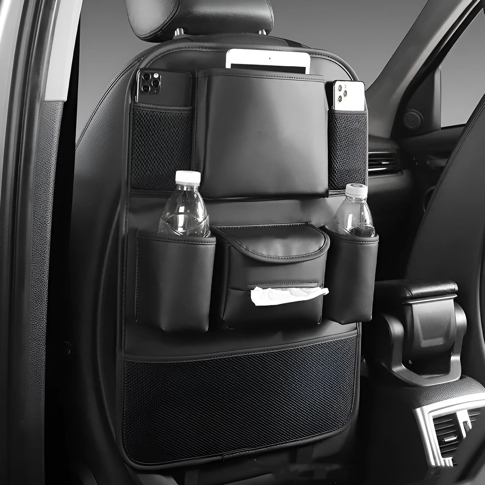 Leather car seat back storage bag hanging from vehicle headrest with multiple compartments