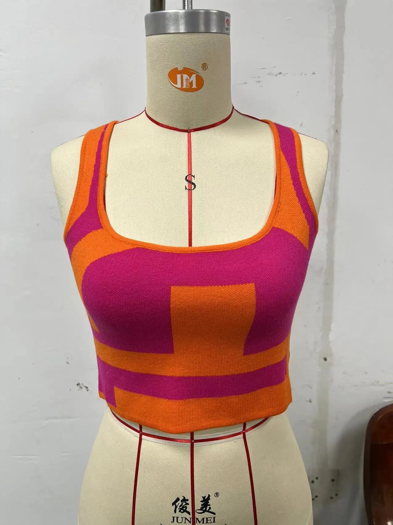 Women's slim fit camisole vest with U collar and exposed navel design in stretch polyester fabric.