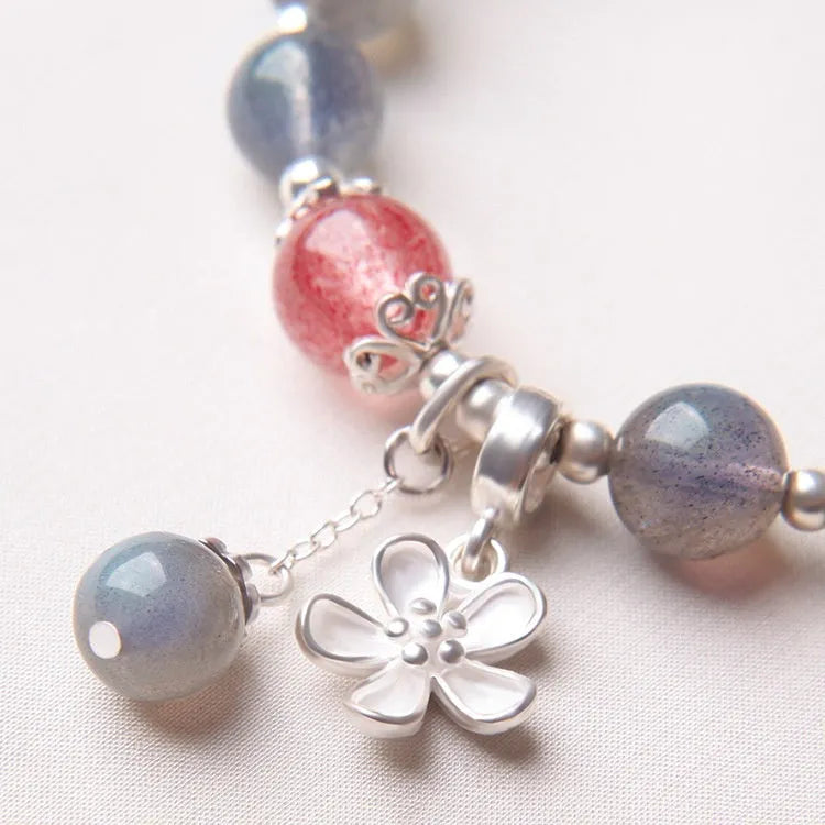 Women's silver bracelet with grey moonstone and zodiac charm.