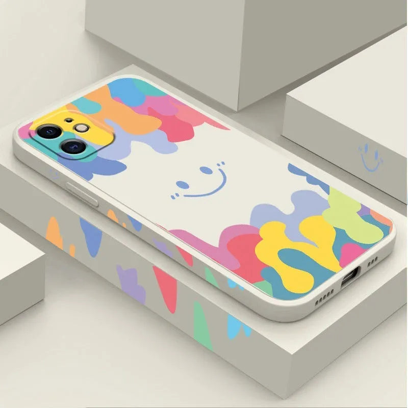 White TPU iPhone case with rainbow smiley face design and attached lanyard