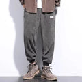 Men's grey straight leg sweatpants with ankle strap detail on a plain background.