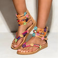 Women's ethnic Roman sandals with floral beaded petal details on a PU upper, round toe.