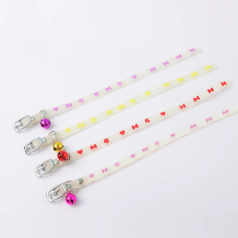 Glow in the dark adjustable silicone cat collar with metal bell in paw print pattern.