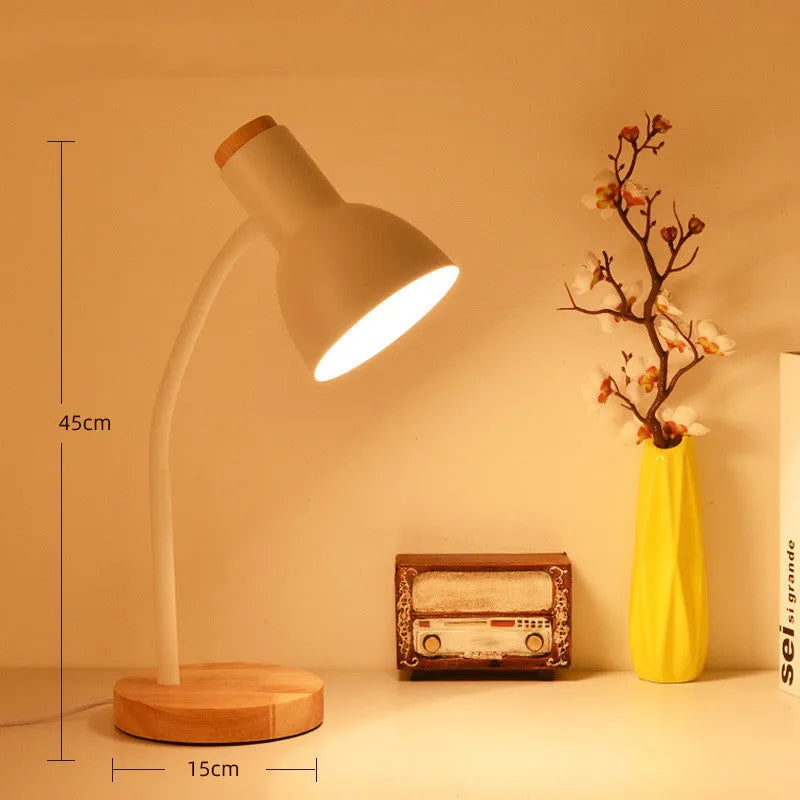 A modern LED table lamp with a push button dimmer switch on its base.