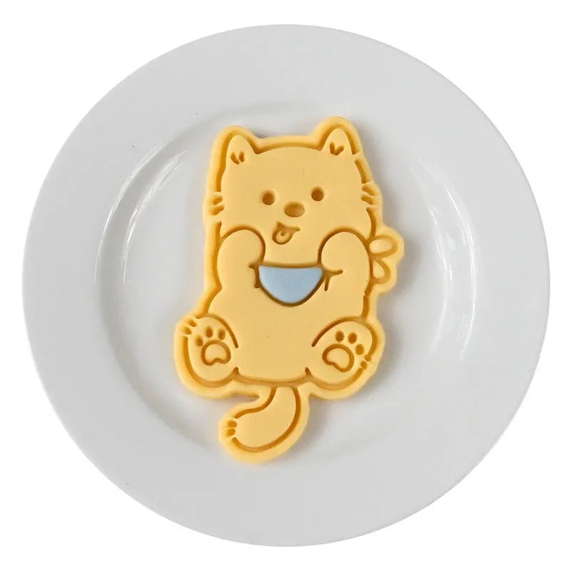 Plastic press mould for making puppy-shaped biscuits and soft candies with cartoon designs.