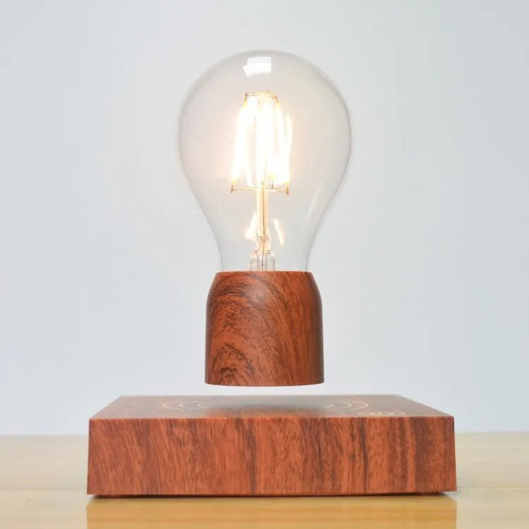 Magnetic levitation floating light bulb hovering above a wood-effect base.