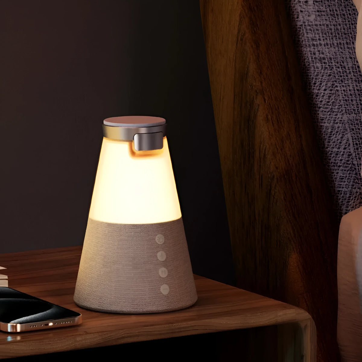 Gray 3-in-1 magnetic wireless charging Bluetooth speaker night light on a wooden table