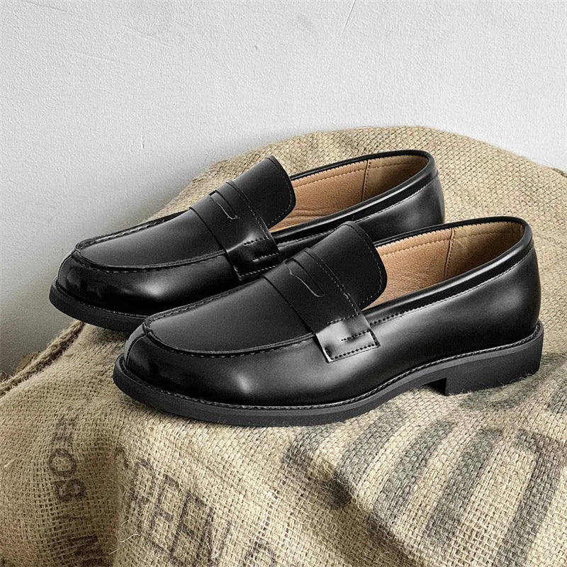 Black men's slip-on derby leather shoes with a rubber sole on a white background