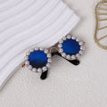Pearl-rimmed round sunglasses for a cat or dog on a festive background.