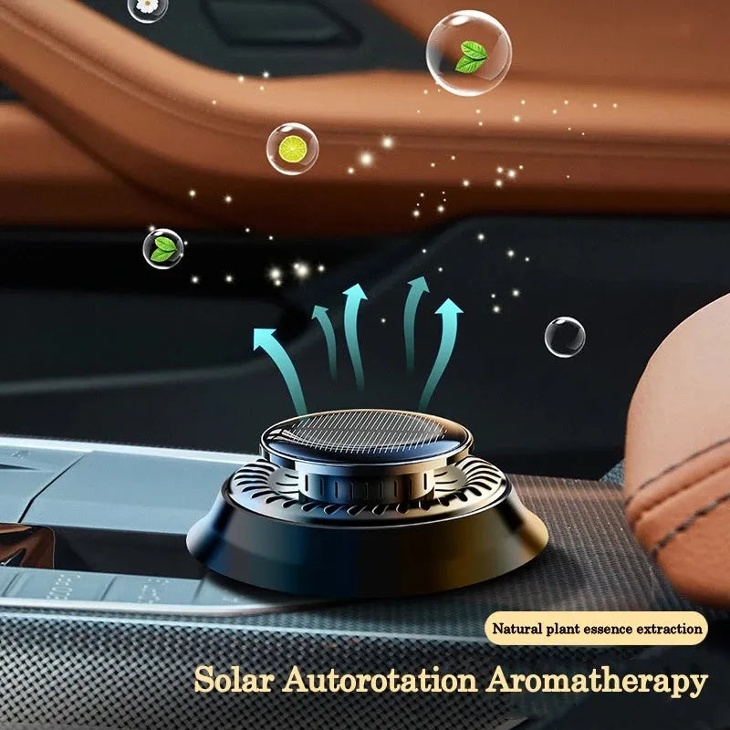 Solar-powered kinetic car air freshener with double ring rotating mechanism on car dashboard