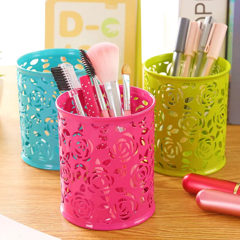 Metal round pen holder in Rose Red on a desk holding pens and pencils