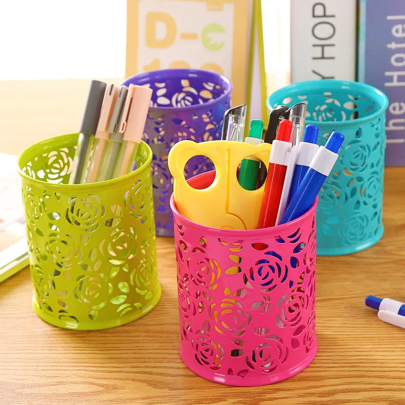Metal round pen holder in Rose Red on a desk holding pens and pencils