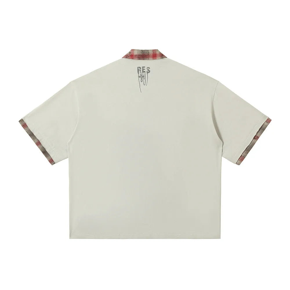 Men's loose asymmetric short-sleeved top with graffiti print on lapel in blue or red.