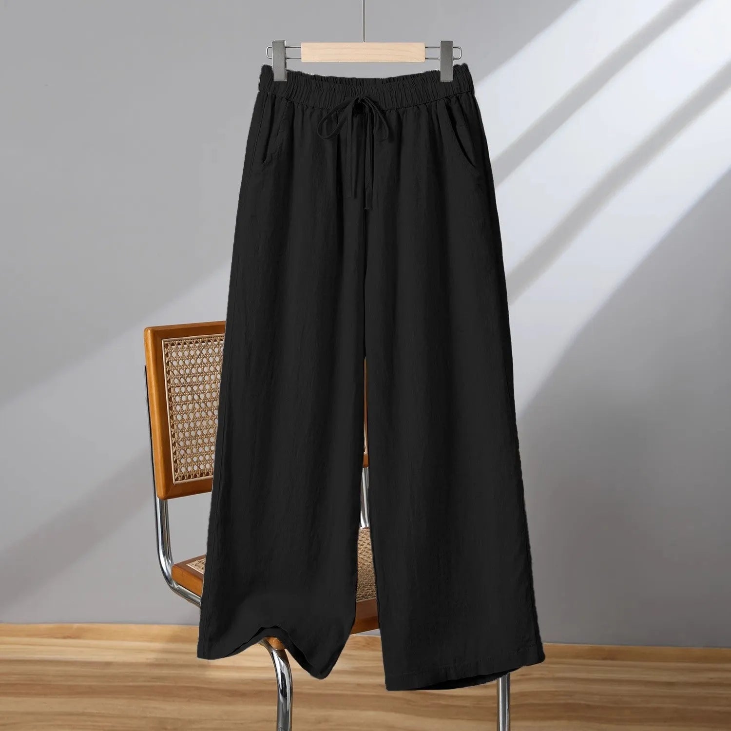 Women's straight-leg casual trousers with elastic waist and lace-up drawstring detail in polyester fabric