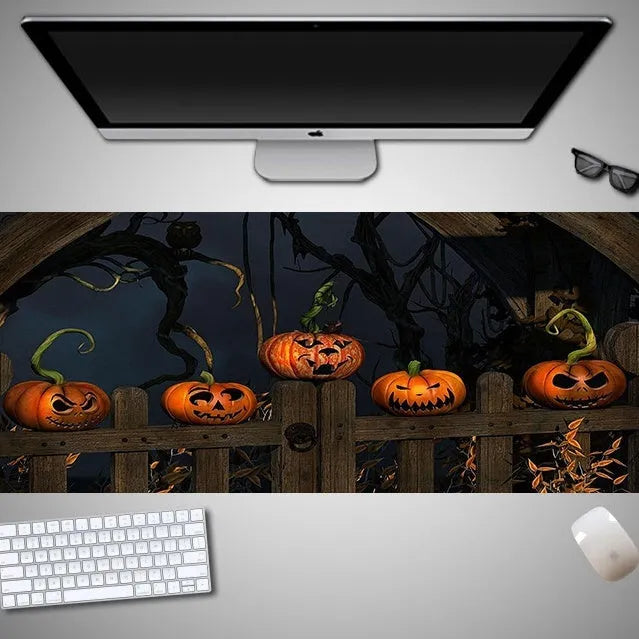 Oversized Halloween-themed gaming mouse pad on a desk, showing anti-slip base and graphic design.