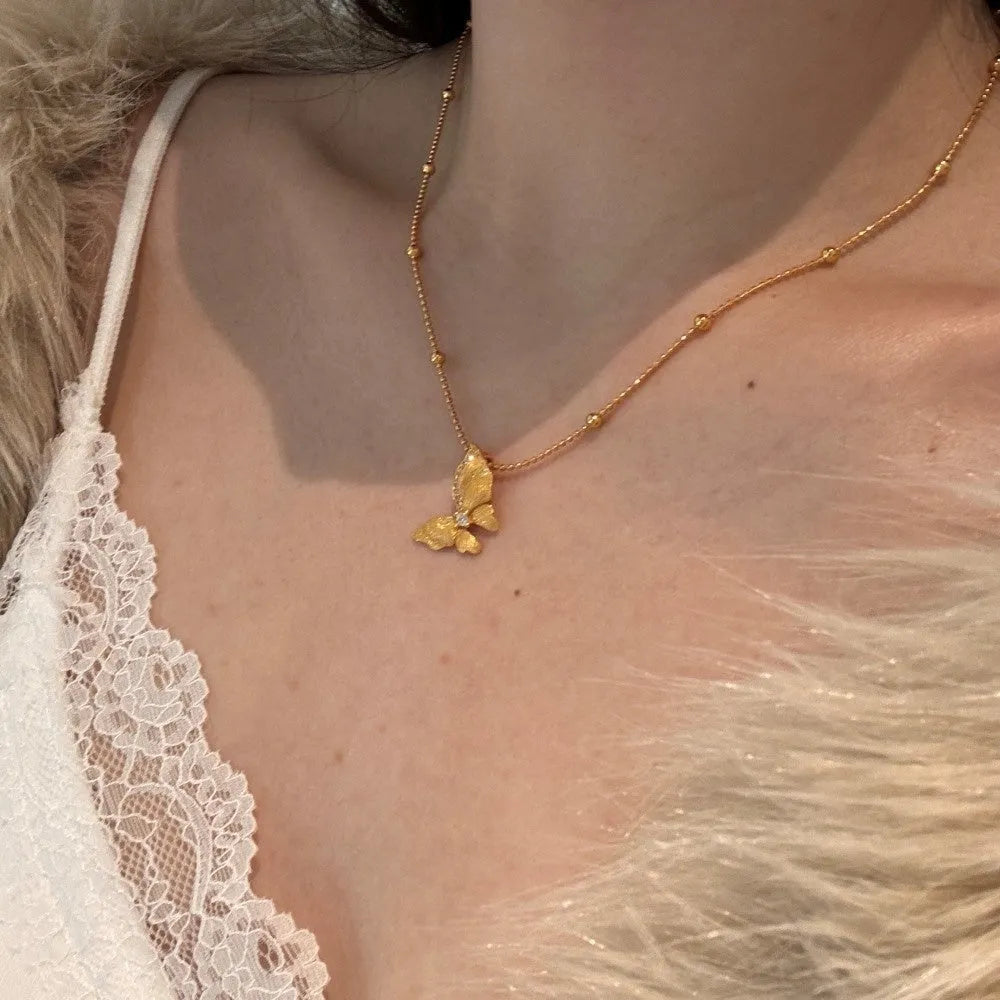 Gold-tone 925 silver butterfly necklace with frosted antique-style pendant on a clavicle chain