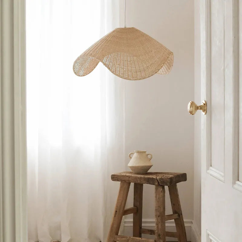 Handmade bamboo and rattan pendant ceiling lamp with a woven willow shade in warm white light.