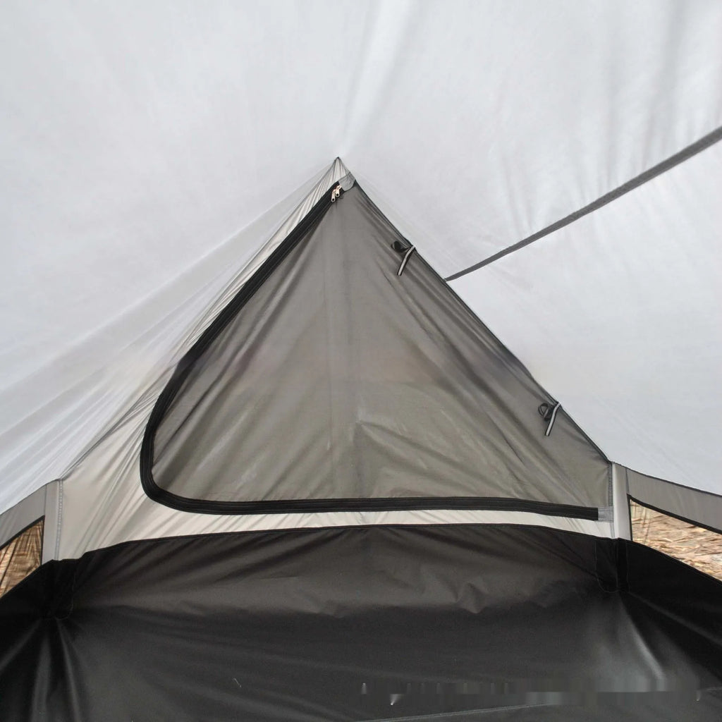 Brown A-line tent pitched with hiking poles, showing guy lines and aluminium ground nails.
