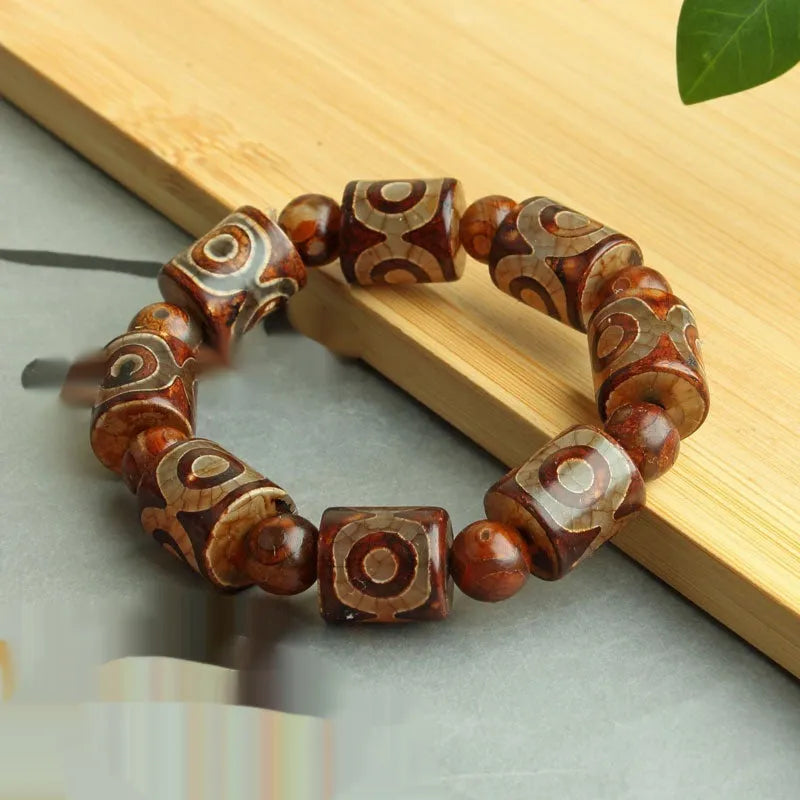 Distressed agate Tibet beads bracelet with three eye dzi design and polished stone beads