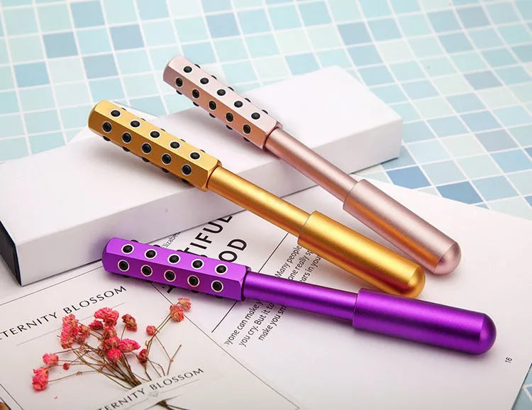 Purple handheld facial massage roller with germanium particles measuring 193mm long