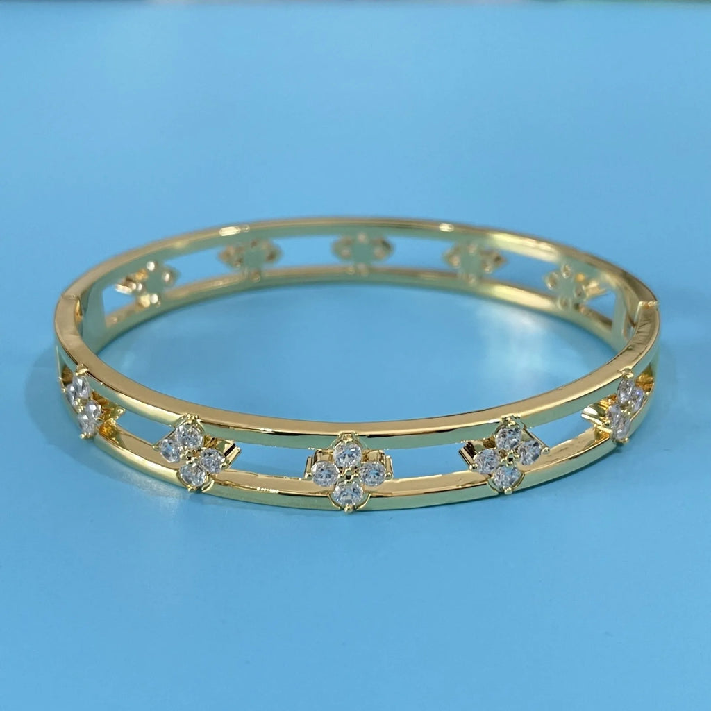 Women's simple hollow bracelet with four-leaf clover charm in gold or silver finish