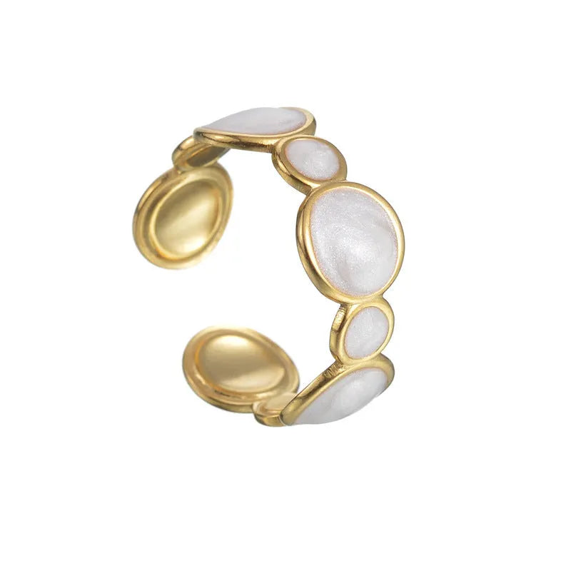 A geometric stainless steel ring with an adjustable opening on a plain background.