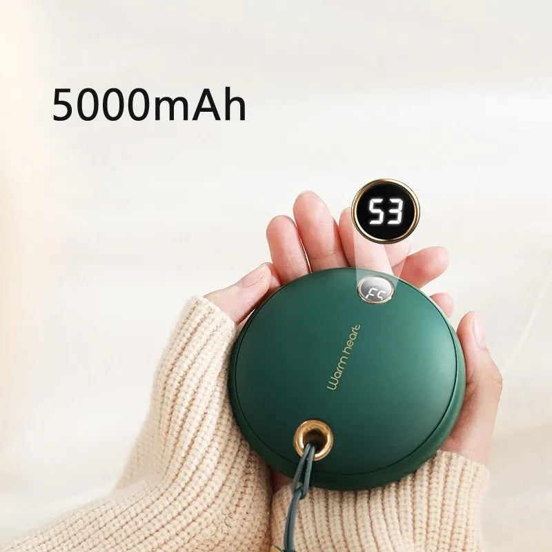 Green, pink, or white hand warmer power bank with digital display showing charge level