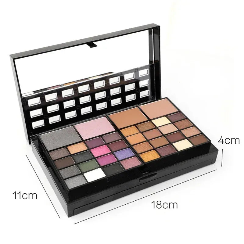 74 colour makeup palette open showing layered powder plates with eyeshadows, lip glosses, blush and contour, with mirror and brushes.