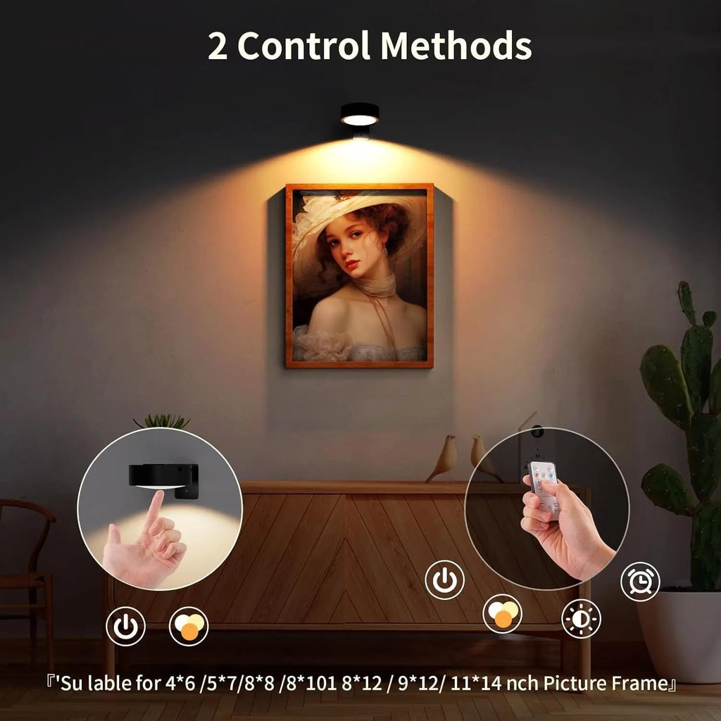 Magnetic LED light bars mounted around a painting, with a remote control on a table nearby.