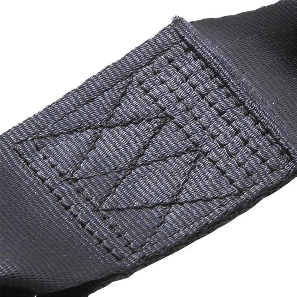 Black polyester pregnancy seat belt extender with double aircraft buckle installed on a car seat