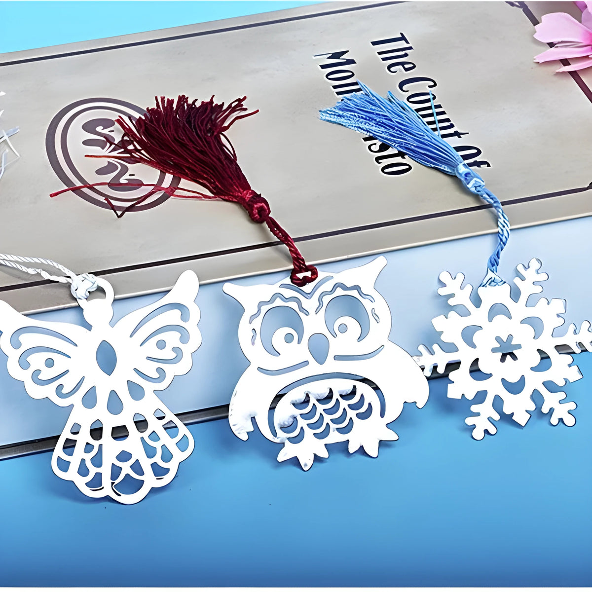 Simple modern stainless steel cartoon bookmark in pink crown design on an open book page