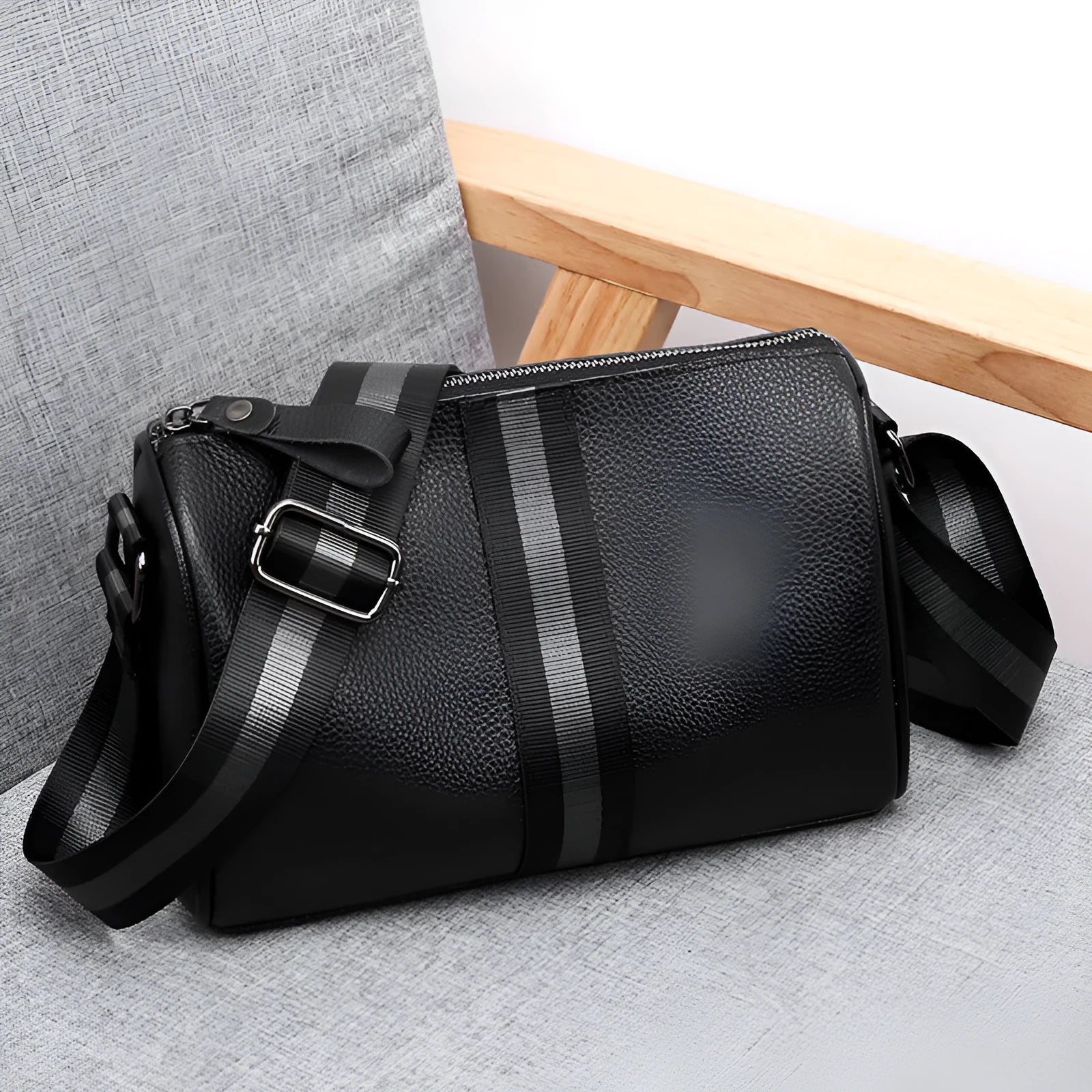 Black genuine leather women's crossbody bag showing front view and adjustable strap