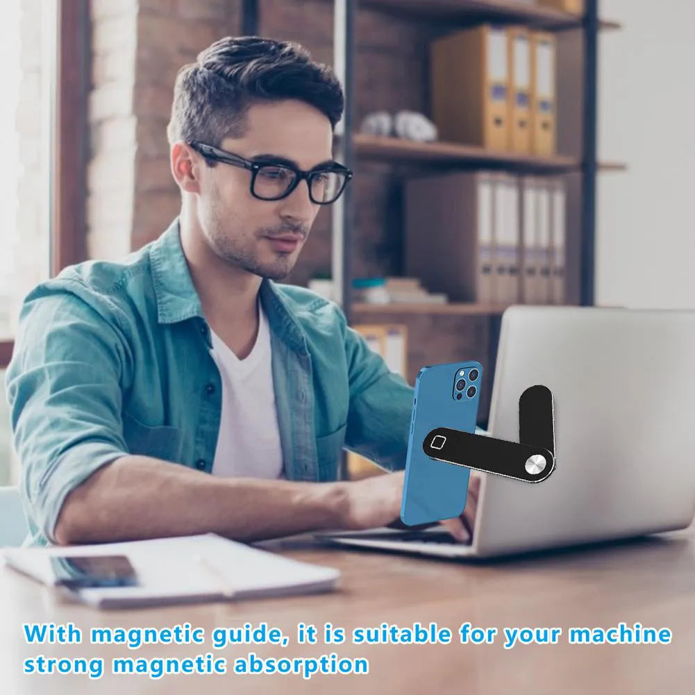 Black aluminum laptop phone holder clipped to a monitor, holding a smartphone and with headphones hanging from the hook.