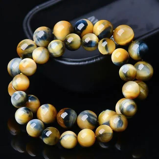 Handmade fantasy tiger eye agate bracelet with round beads on a neutral background.