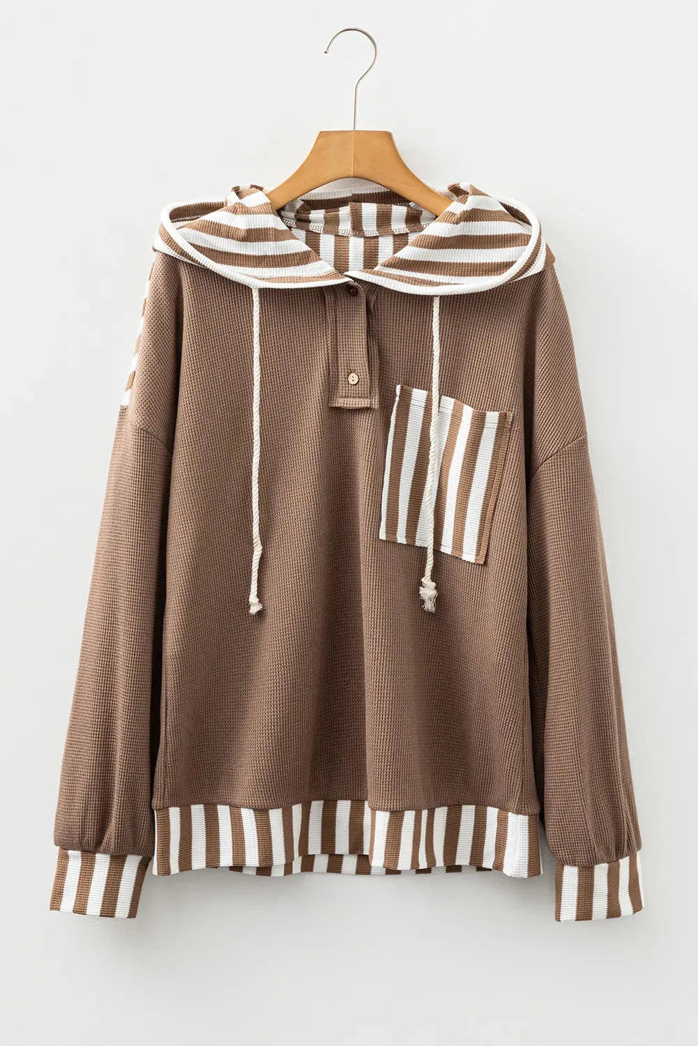 Straw yellow hoodie with waffle texture and striped patchwork design, showing front drawstring and button neck.