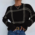Women's loose-fit plaid sweater with colour-block stripes in apricot, black, beige, red, and green.