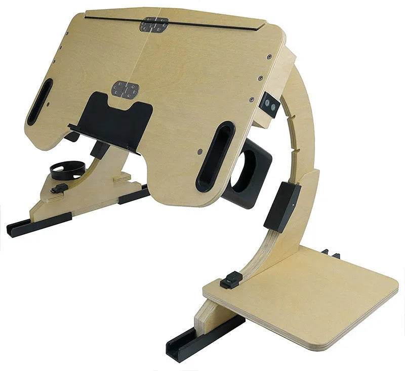 Wooden folding computer desk on a bed showing adjustable angle and laptop.
