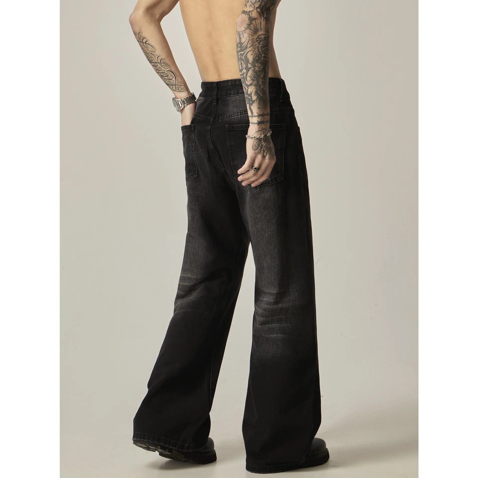 Black loose-fit straight-leg retro jeans with a zipper fly on a mannequin