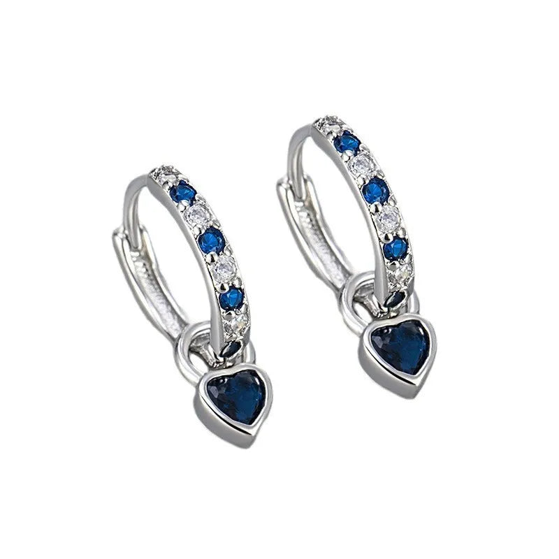 Women's heart-shaped drop earrings with coloured zircon or corundum stone in gold or white gold tone.