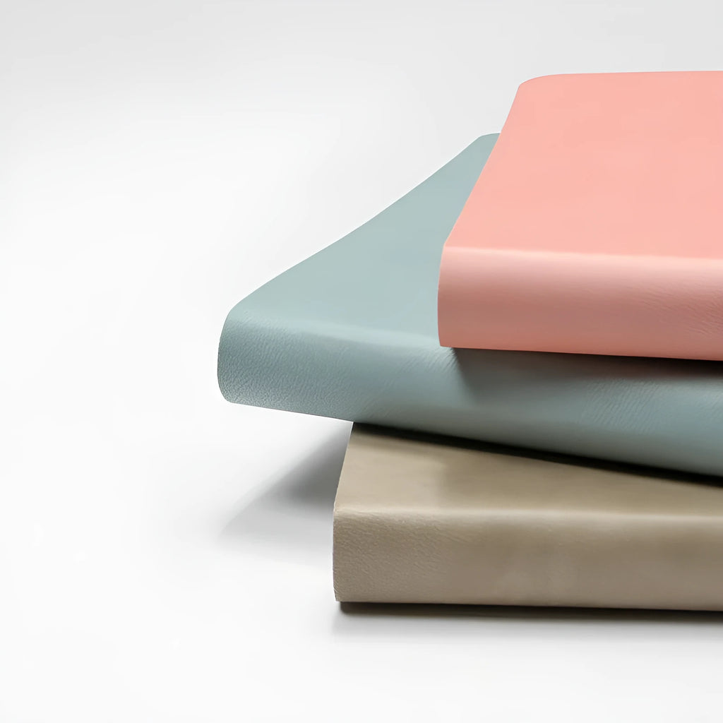 A5 dotted notebook with imitation leather cover in blue or pink colour options showing dot matrix interior pages