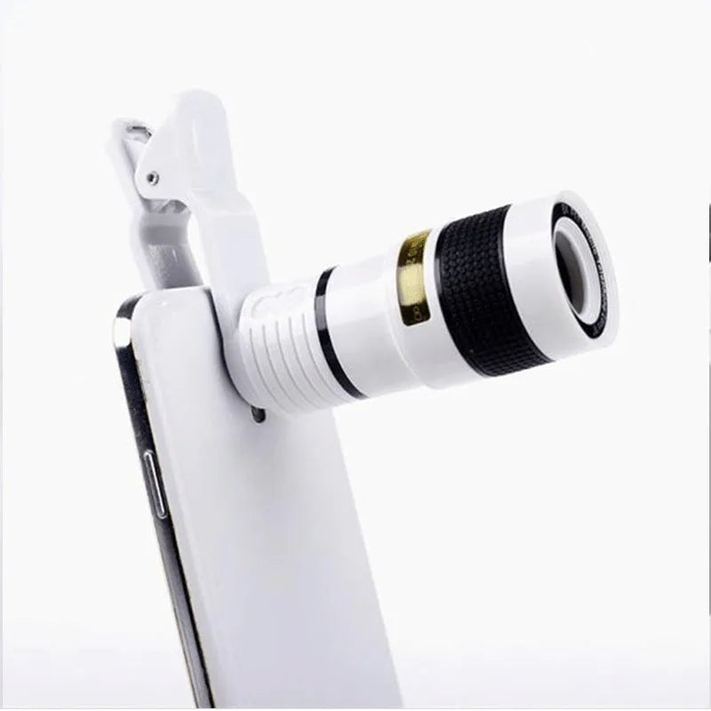 12X magnification phone telescope lens with mounting clip and cleaning cloth on a table.