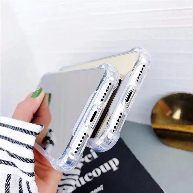 Mirrored front TPU protective case for iPhone in multiple colour options on a table.