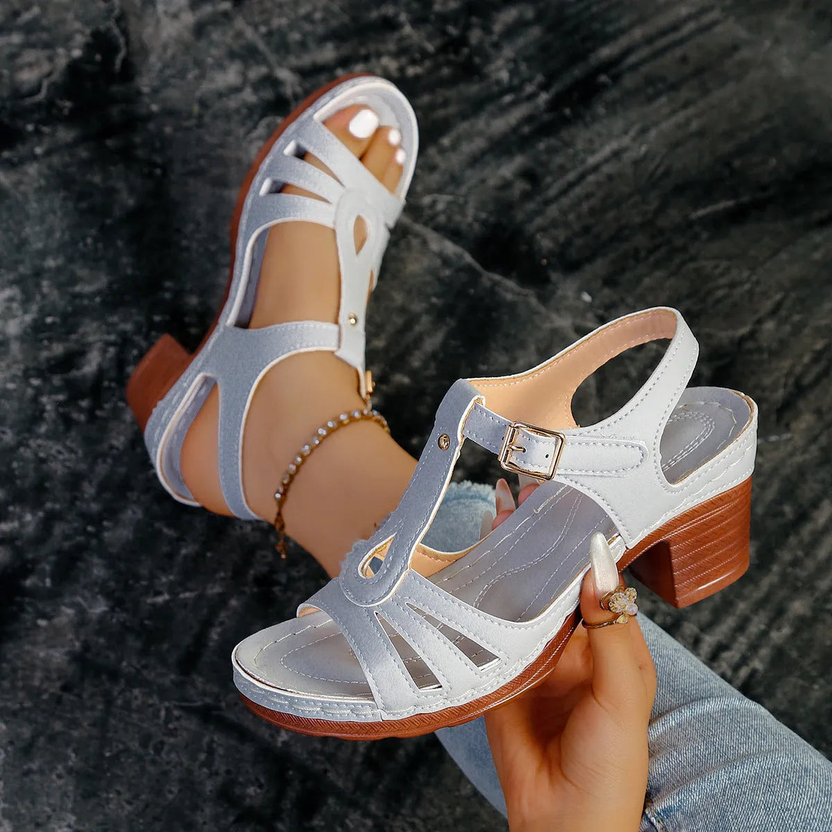 Women's black peep toe wedge platform sandals showing buckle fastening and fish mouth toe design.